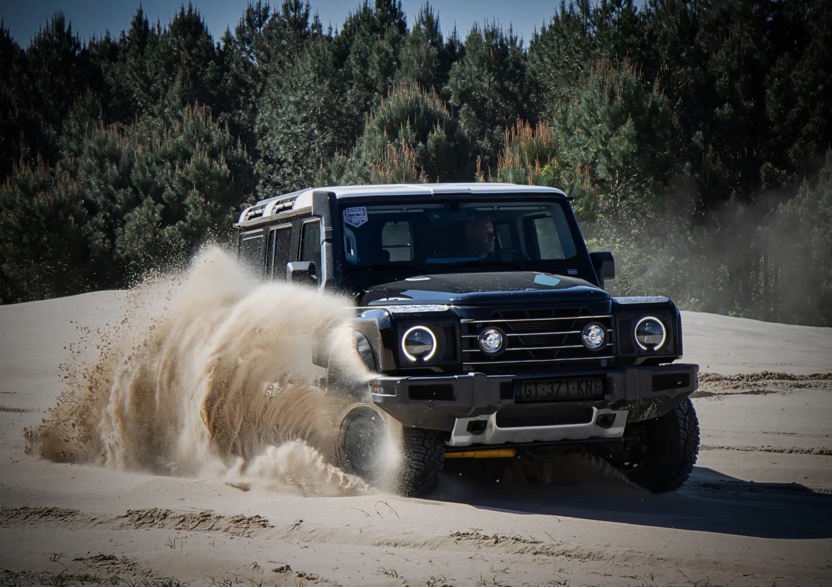A 4x4 driving hard through deep sand on Nimbus suspension